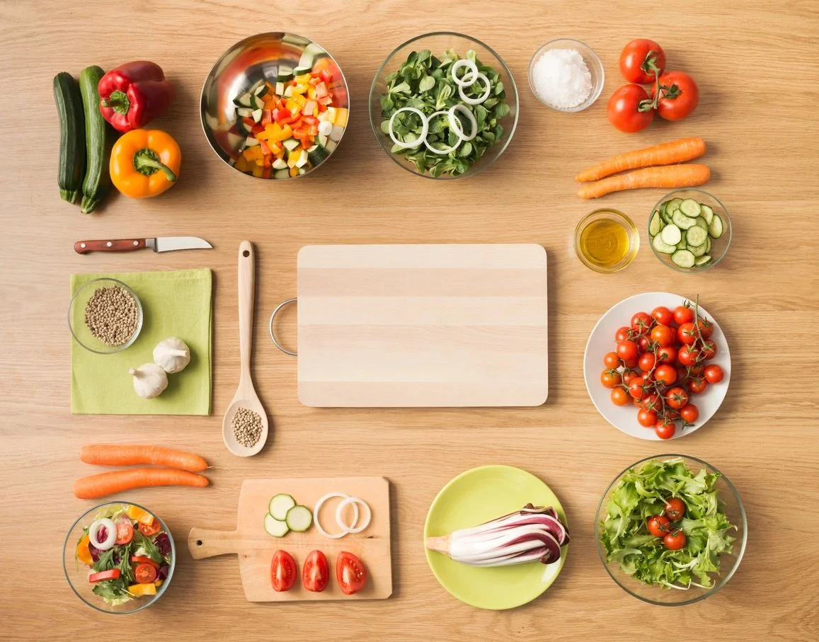 Fresh vegetables, grains and prepared meals arranged on a table